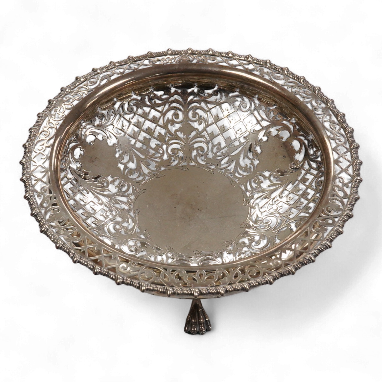 A George V pierced silver bowl, with gadrooned border, on three paw feet, James Dixon & Sons, Sheffield, 1931, diameter 20.8cm, 15oz.